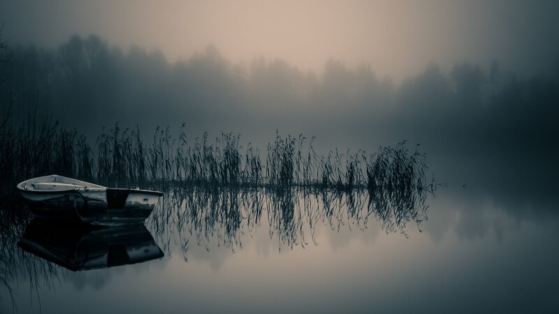 Foggy lake with boat