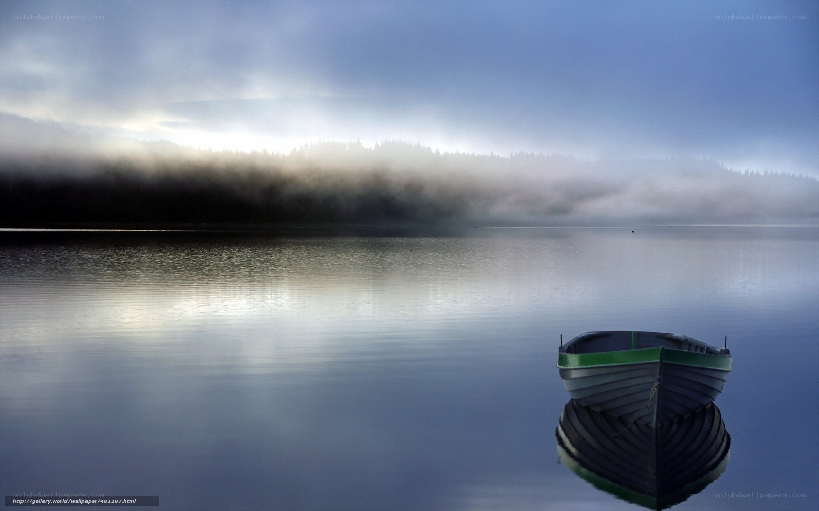 Foggy lake with boat