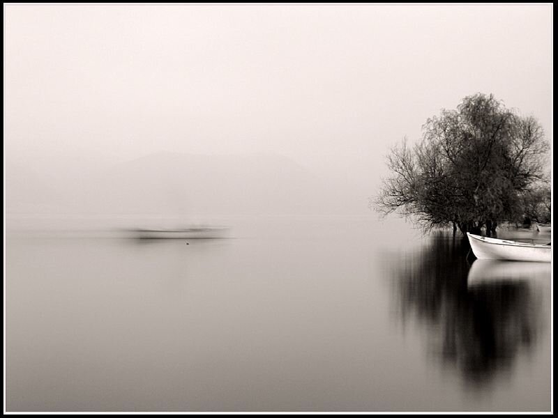 Foggy lake with boats
