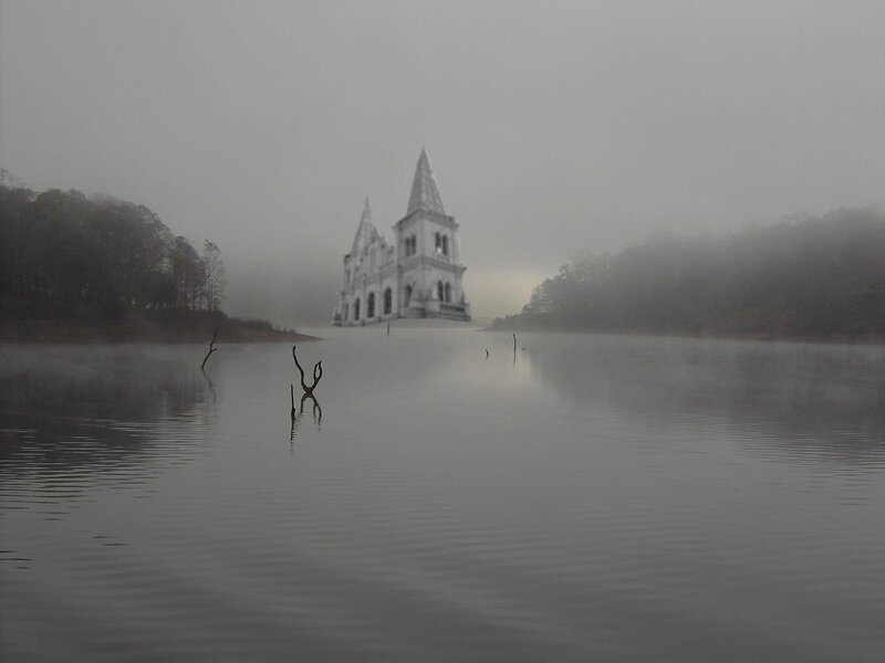 Foggy lake with church