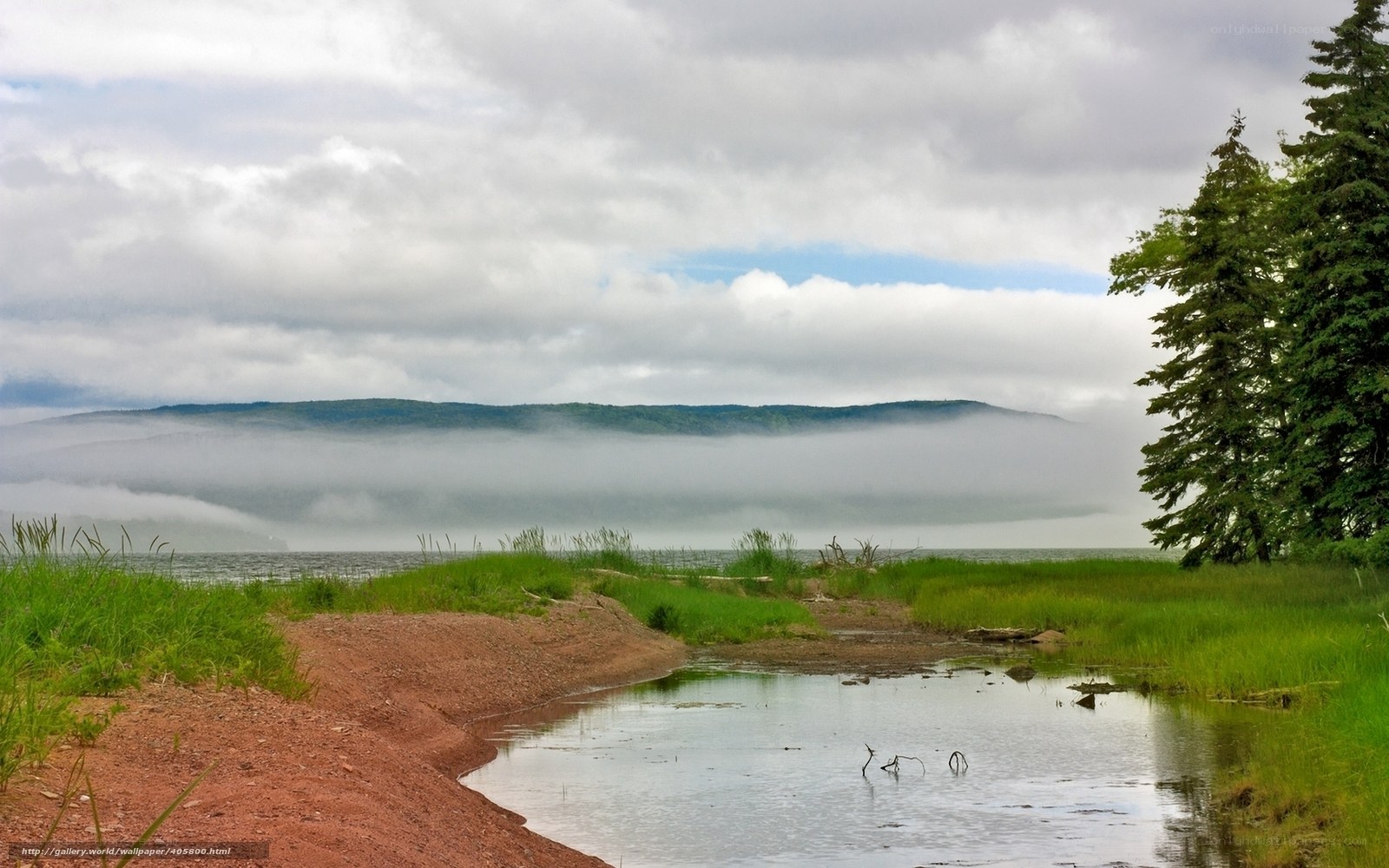 Foggy lake with forested hills