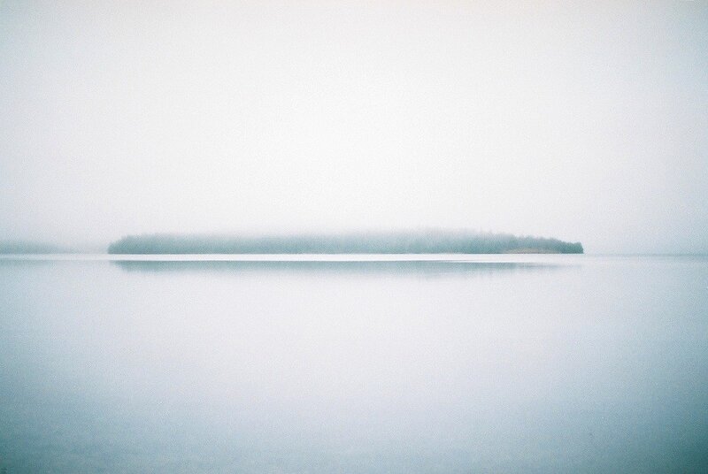 Foggy lake with island