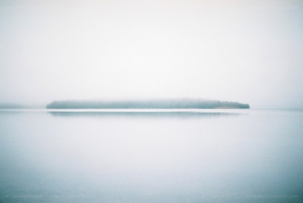 Foggy lake with island