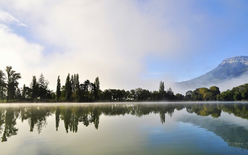 Foggy lake with mountain reflection