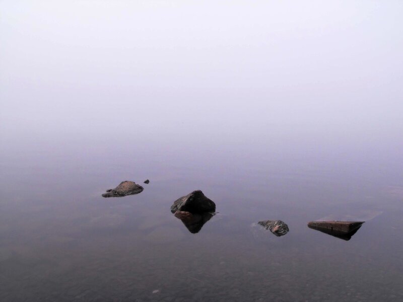 Foggy lake with rocks