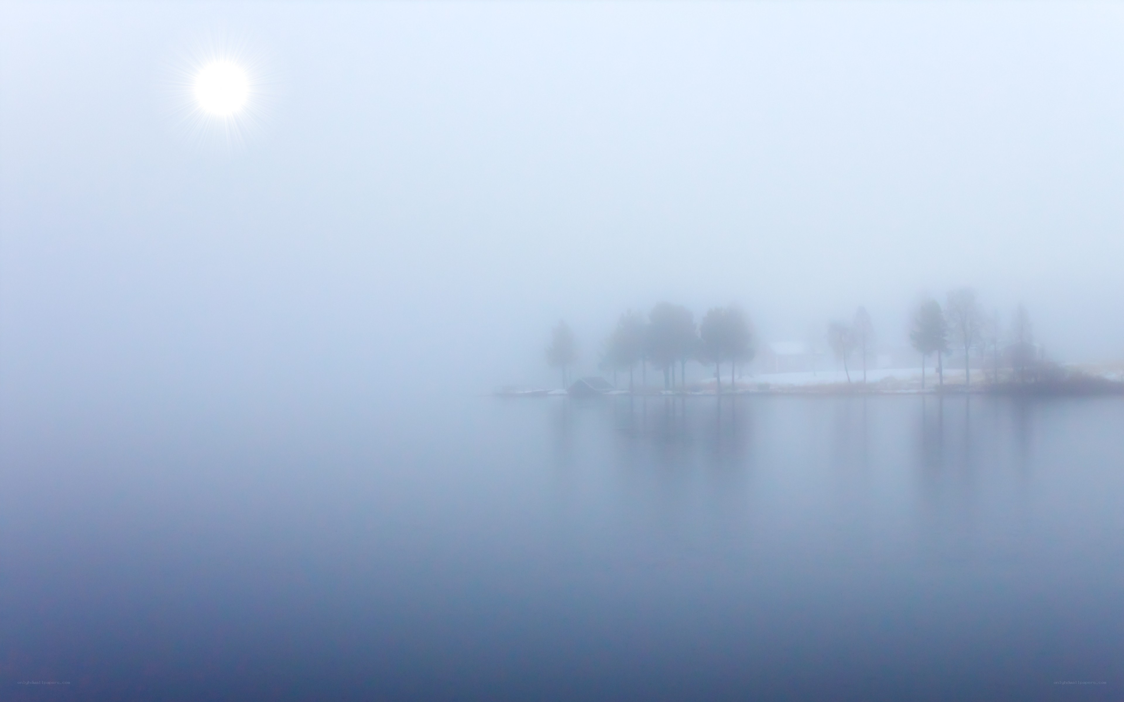 Foggy lake with sun