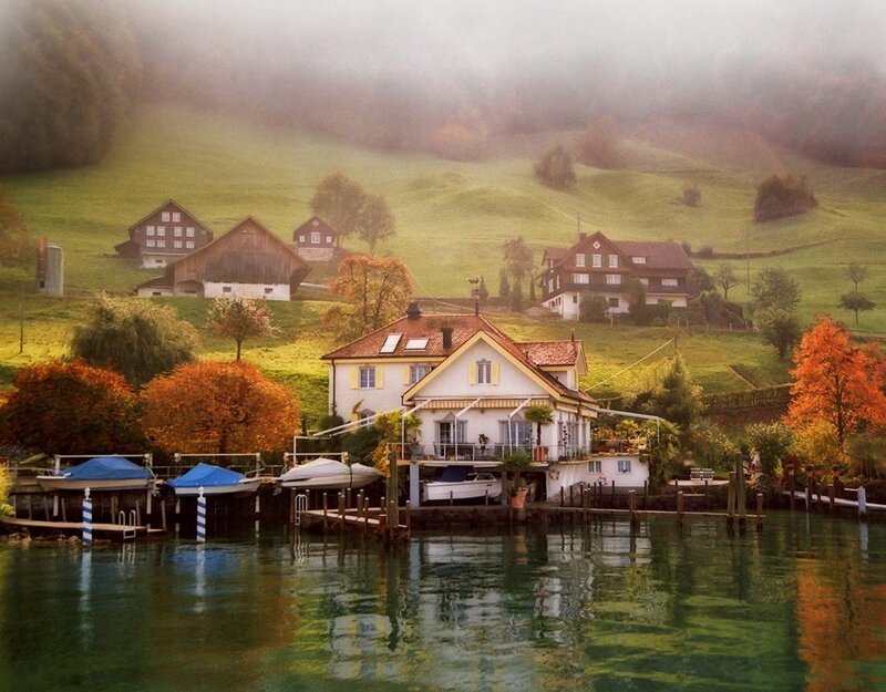 Foggy lakeside village in autumn