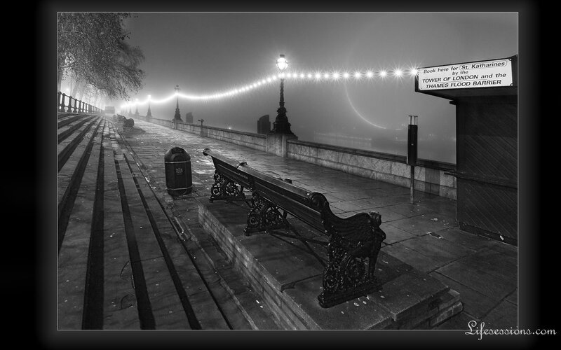 Foggy London riverside at night