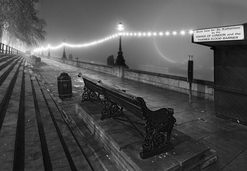 Foggy London riverside at night
