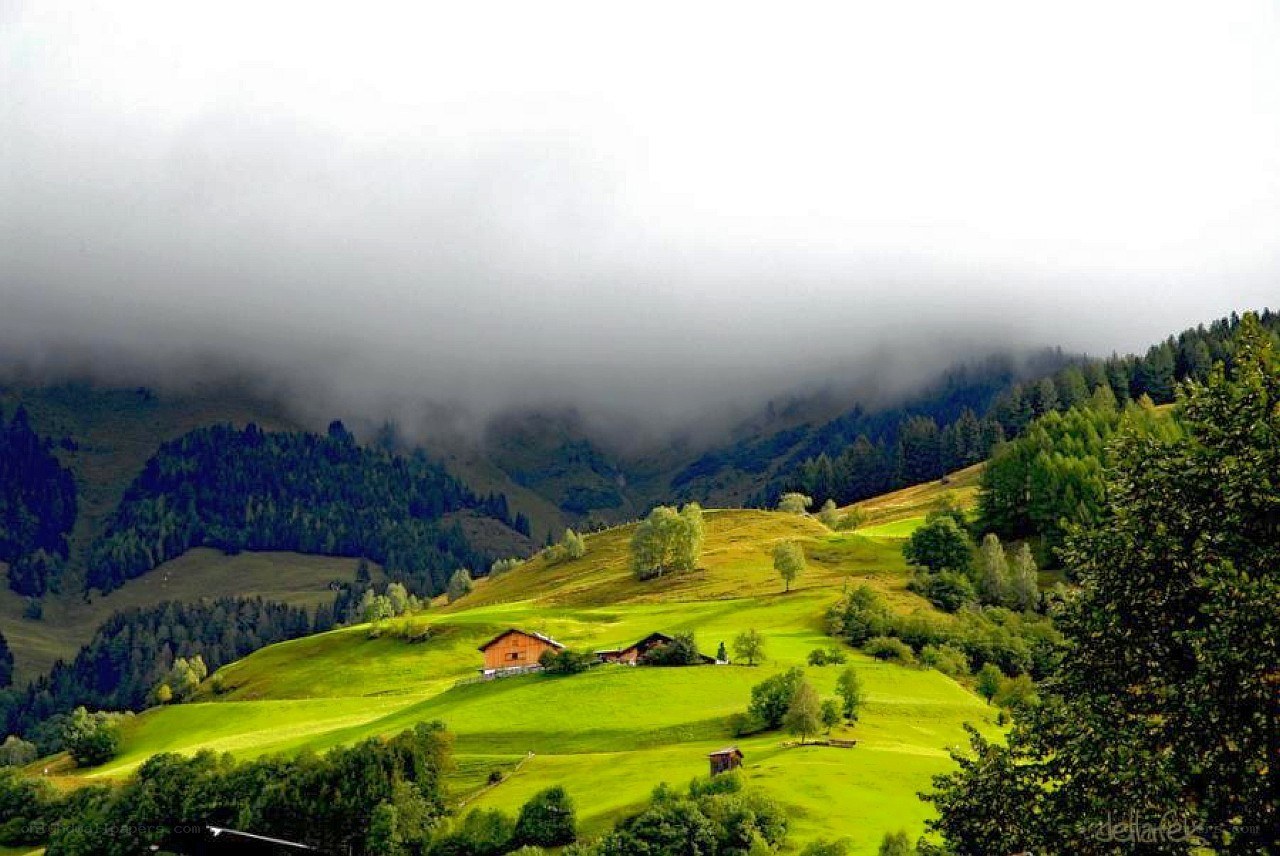 Foggy mountain valley with houses