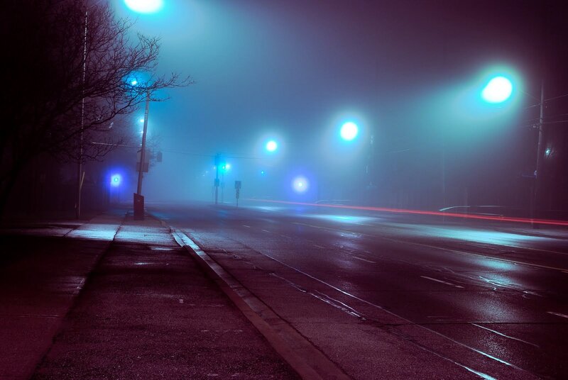 Foggy night street with light trails