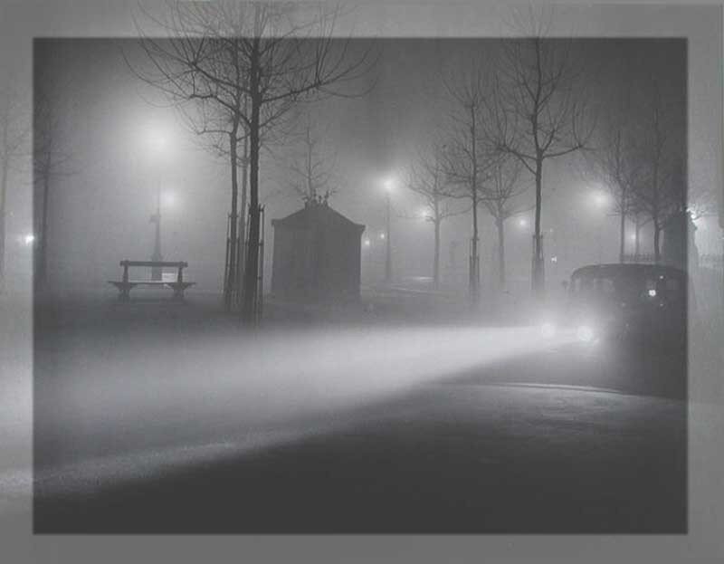 Foggy night with car headlights