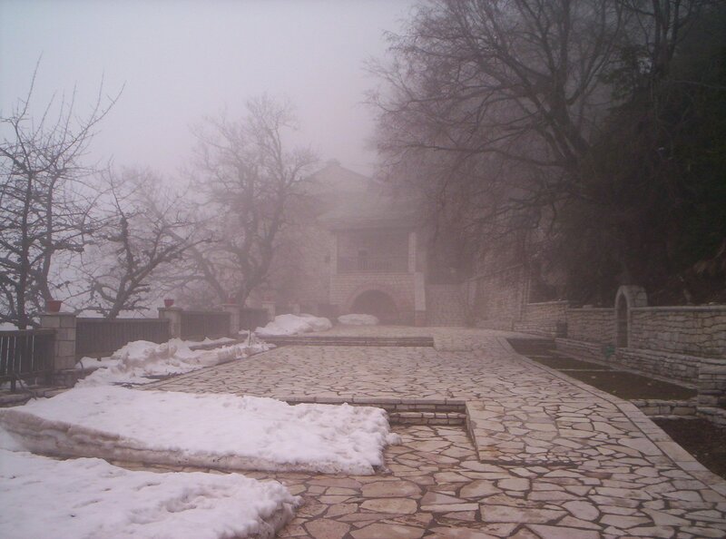 Foggy path to stone building