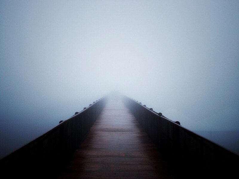 Foggy pier extending into mist