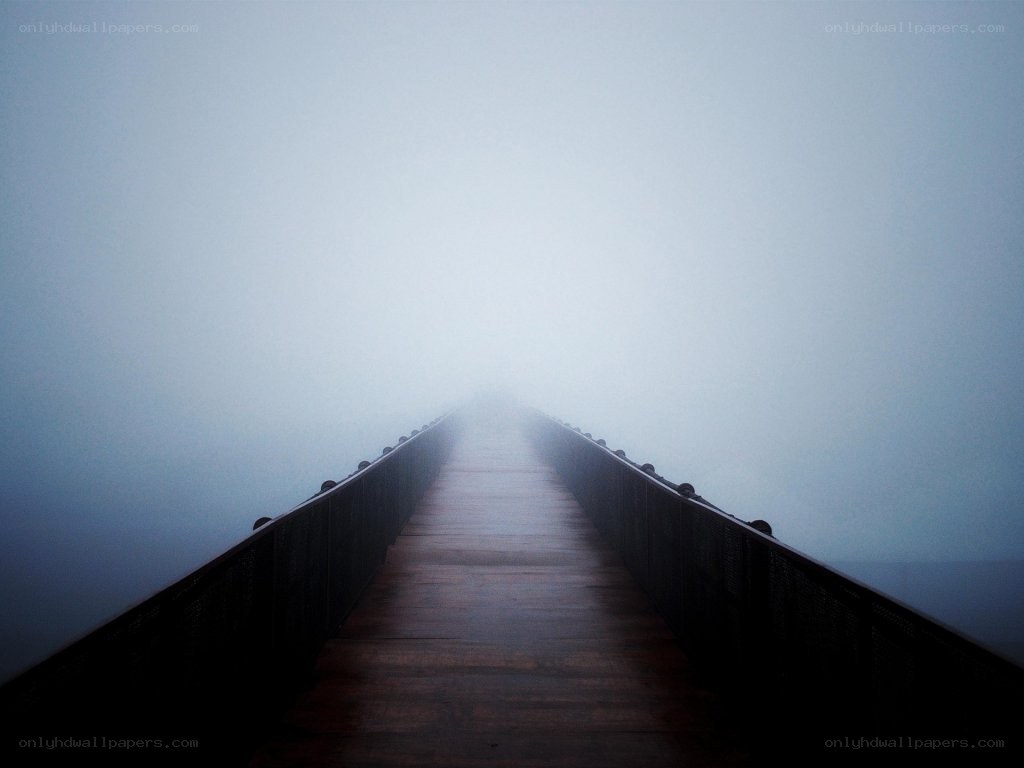 Foggy pier extending into mist