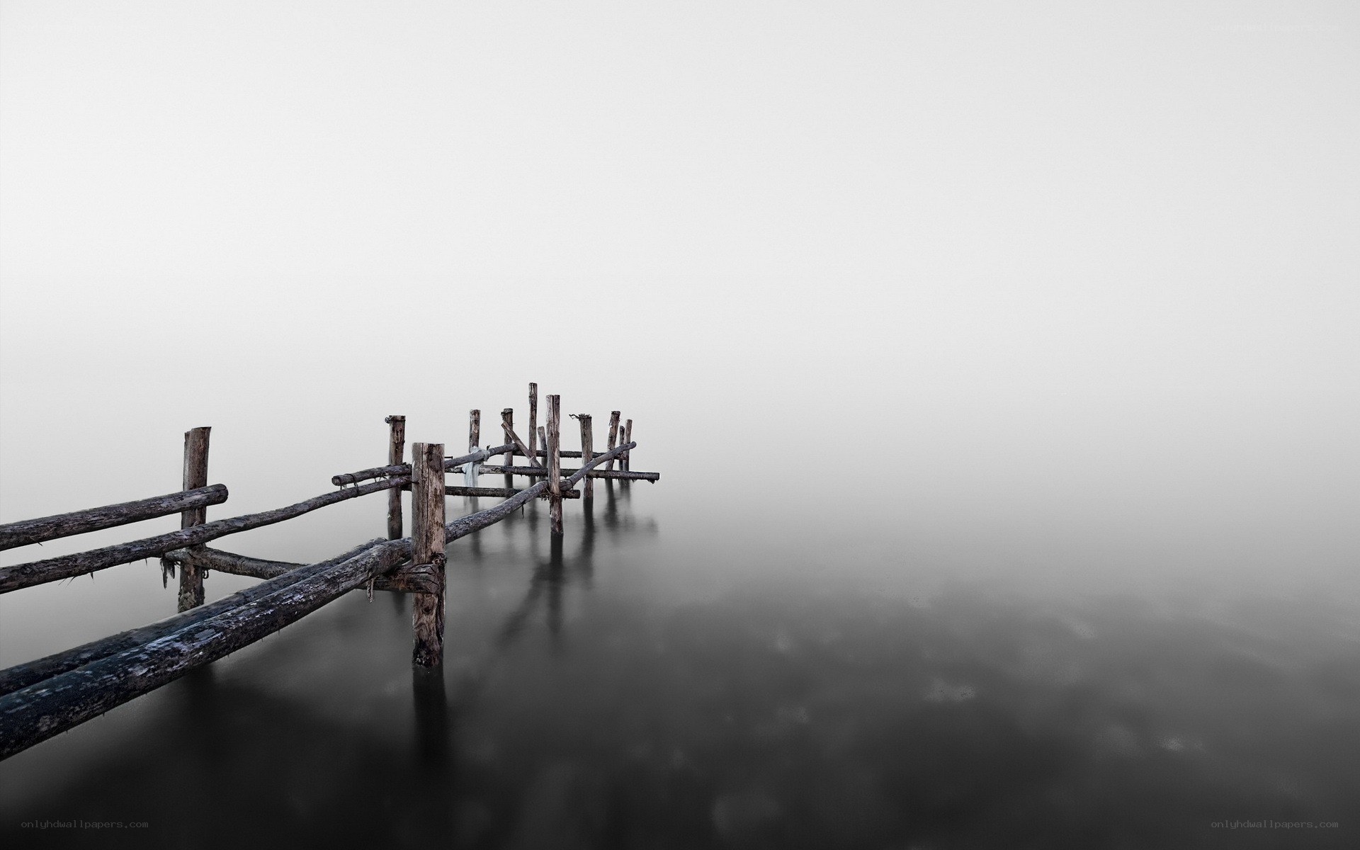Foggy pier extending into mist