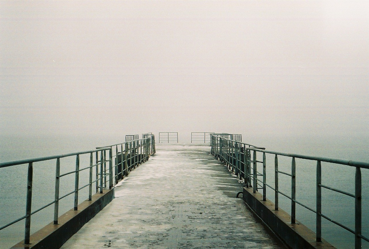 foggy pier extending into water