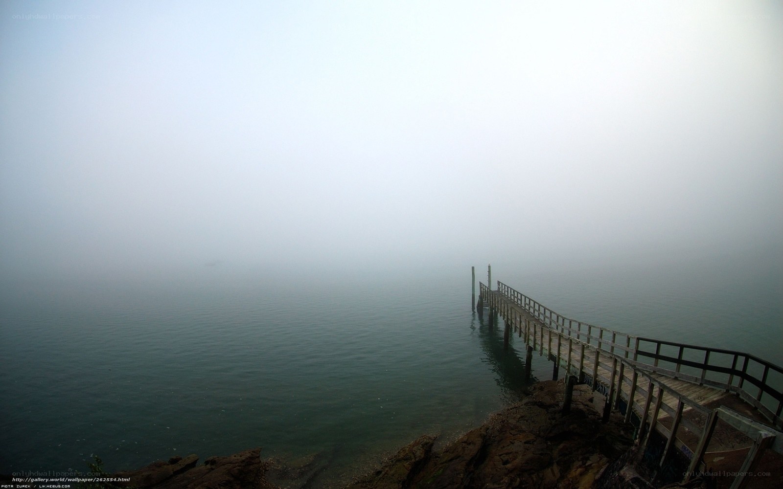 Foggy pier on a calm lake