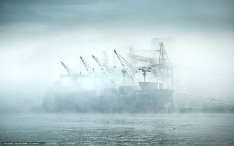 Foggy port with cargo ship