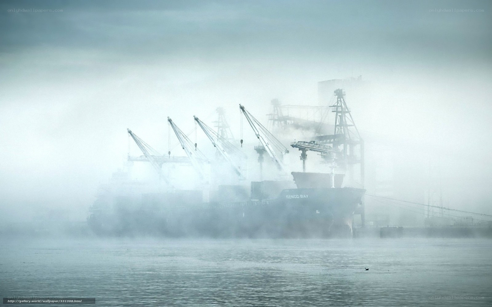 Foggy port with cargo ship