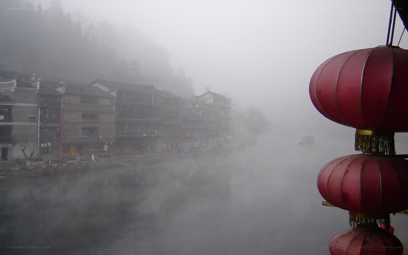 Foggy river town with red lanterns