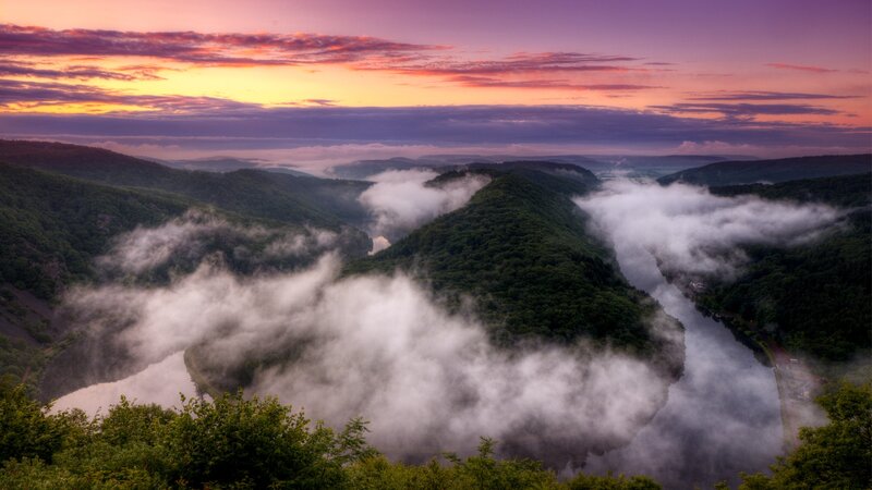 Foggy river valley at sunrise