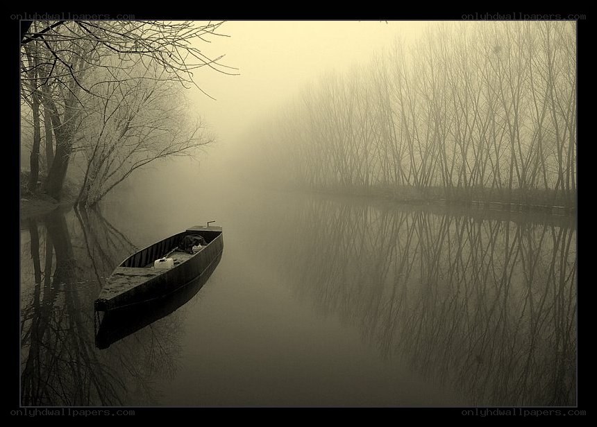 Foggy river with a boat