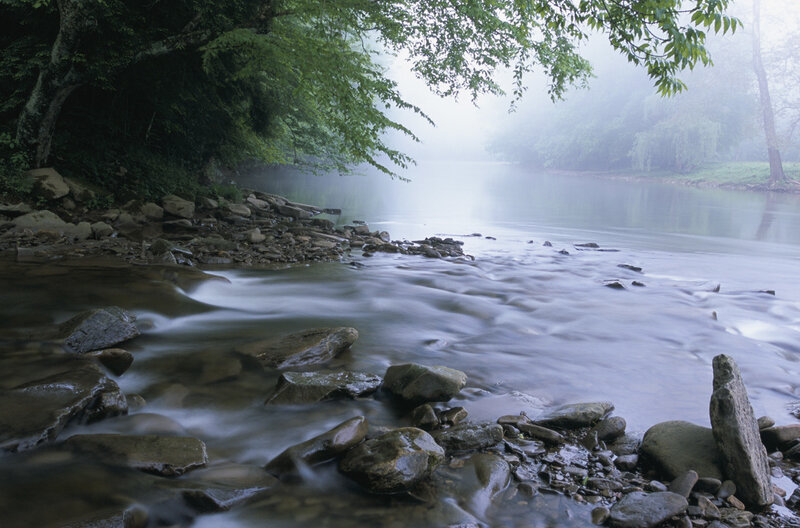 Foggy river with rocks