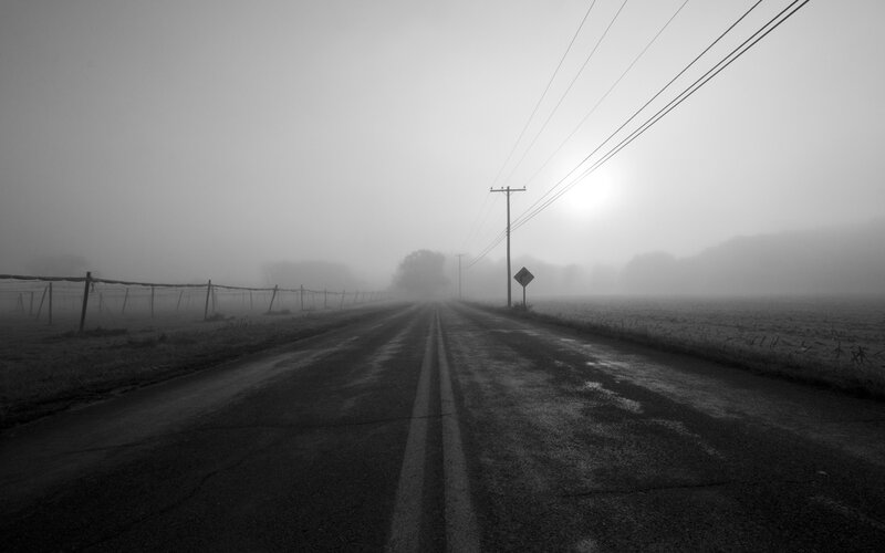 Foggy road at dawn
