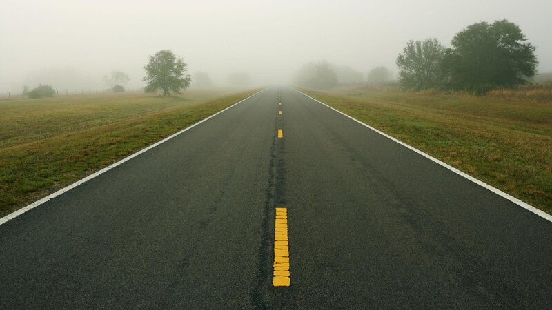 foggy road in rural landscape