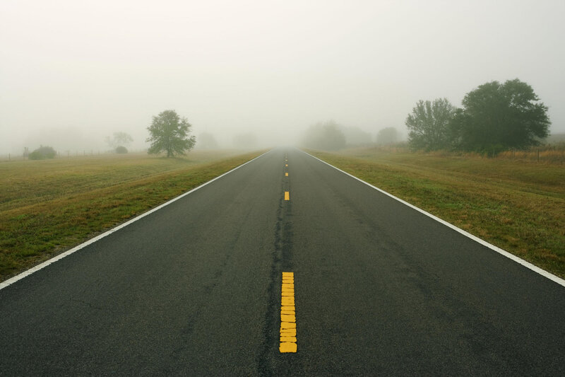 foggy road stretching into distance