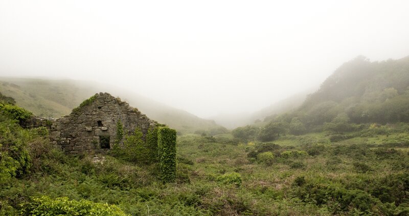 Foggy ruin in a green valley