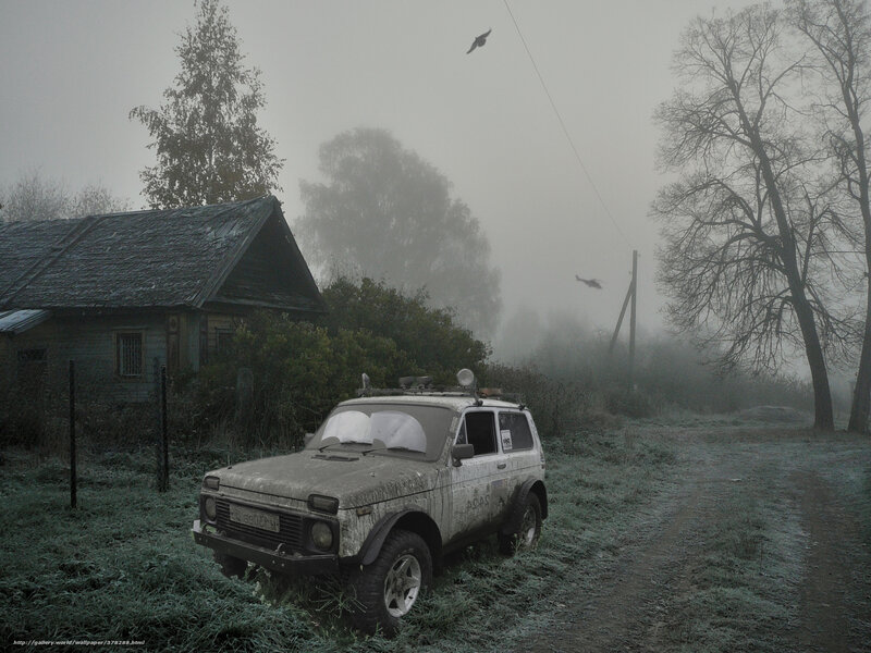 Foggy rural scene with old car