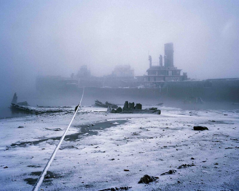 Foggy shipwreck on icy shore