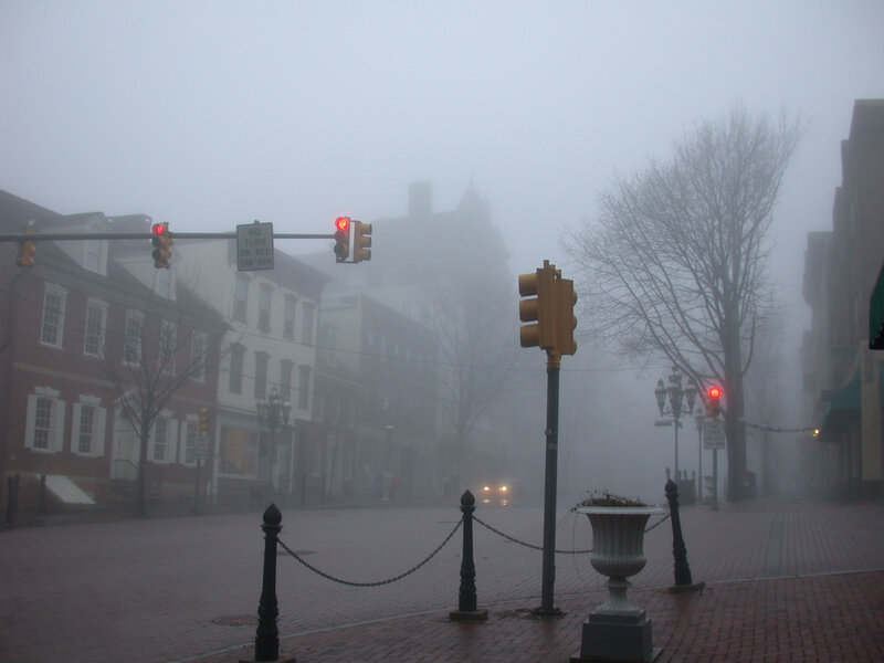 Foggy street intersection with traffic lights