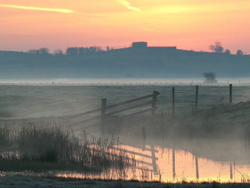 Foggy sunrise over a rural landscape