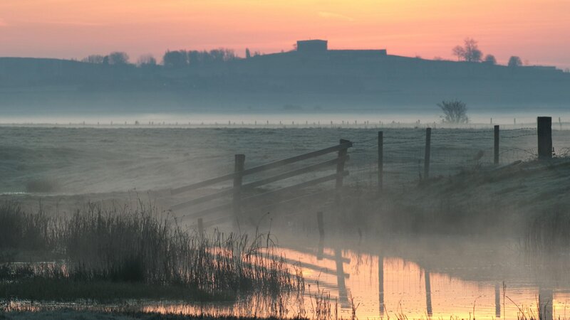 Foggy sunrise over a rural landscape