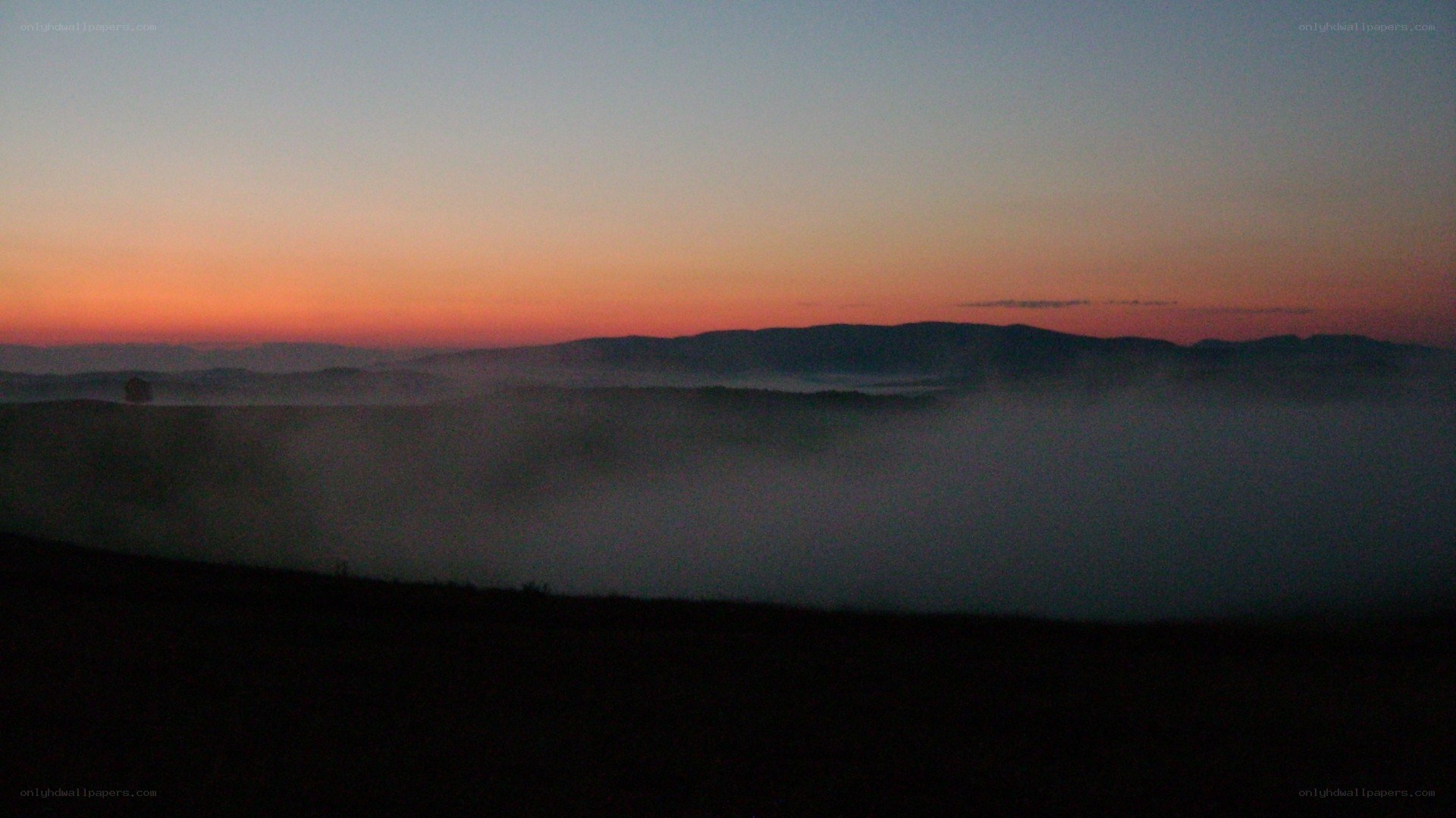 Foggy sunrise over mountains
