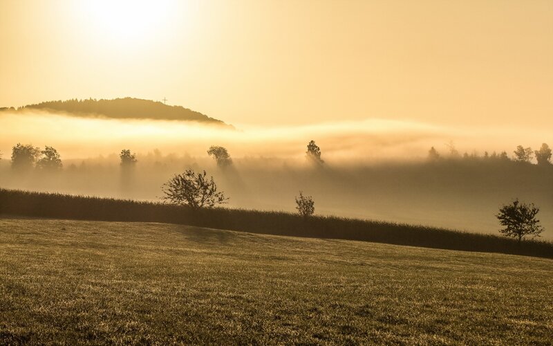 Foggy sunrise over rolling hills