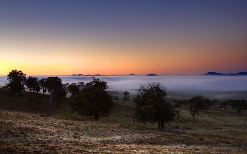 Foggy sunrise over rolling hills