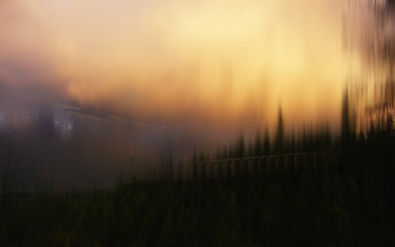 Foggy sunset over buildings