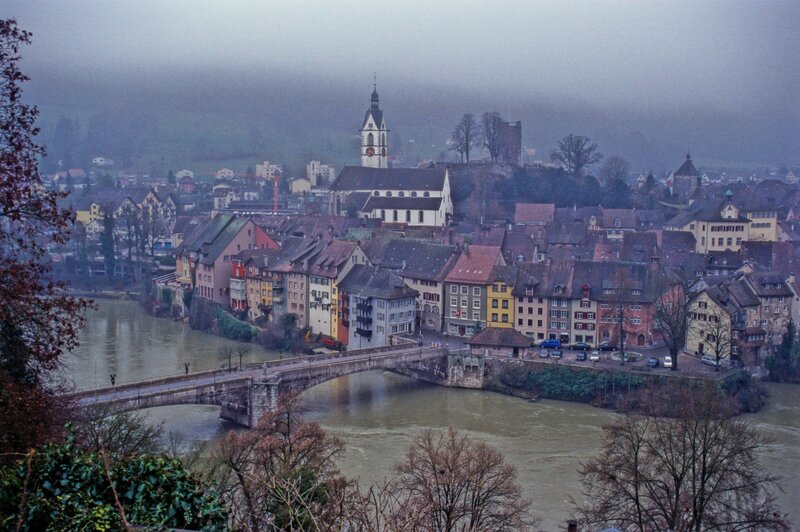 Foggy town by a river
