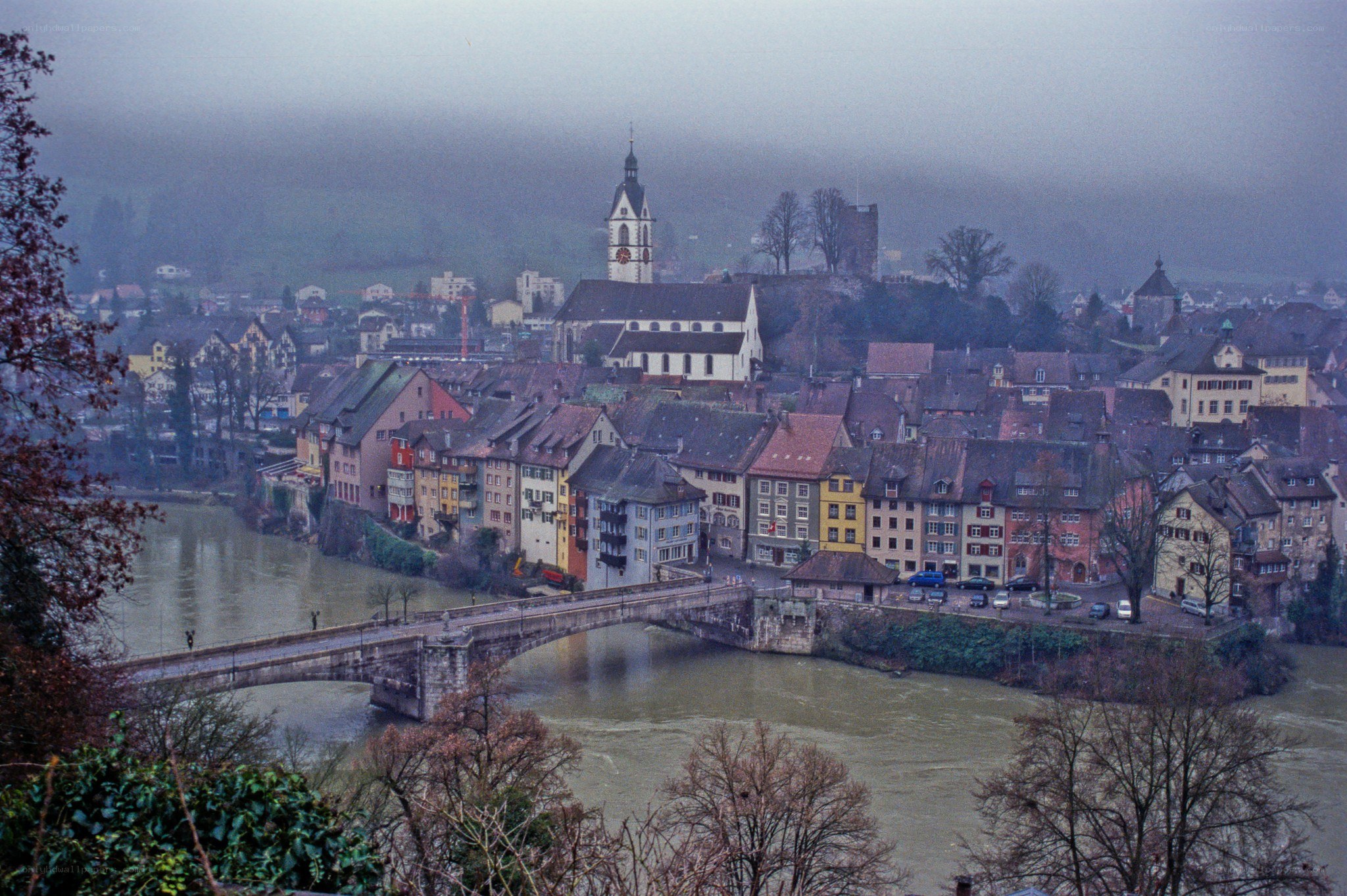 Foggy town by a river