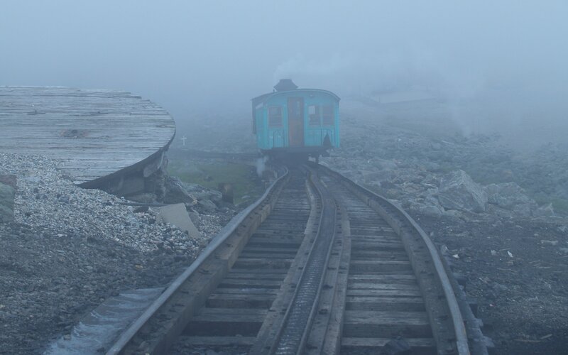 foggy train on mountain tracks