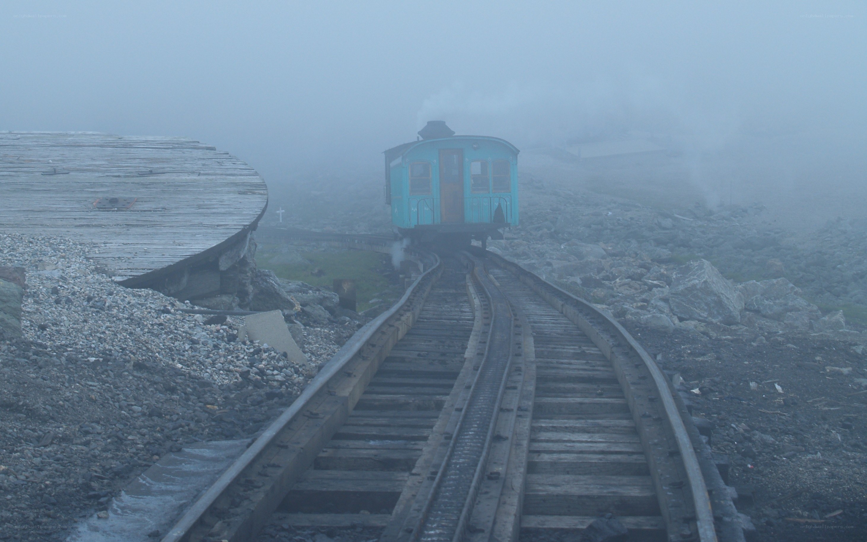 foggy train on mountain tracks
