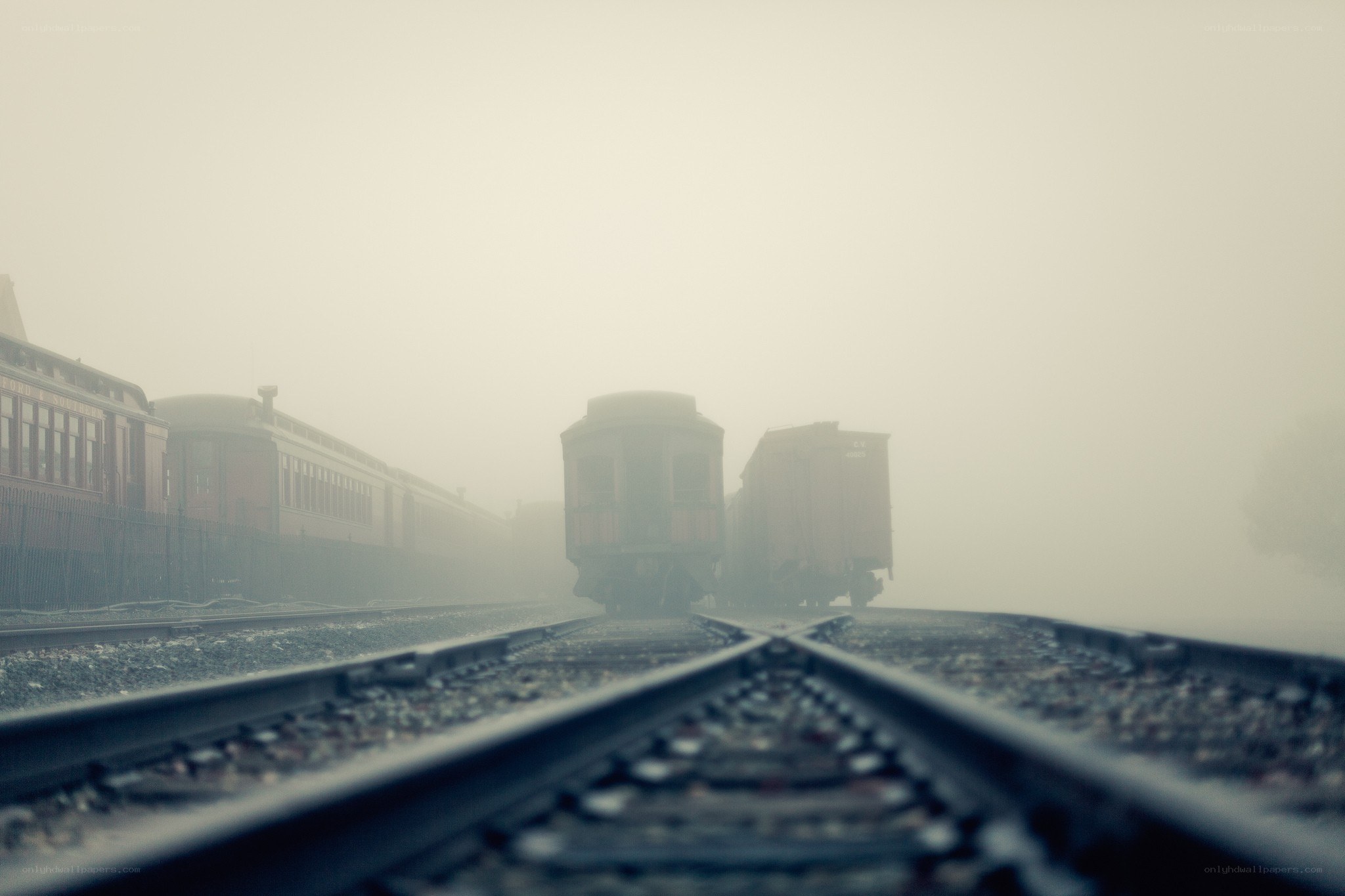 Foggy train yard at dawn