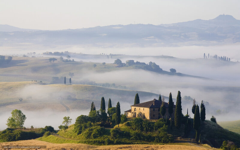 Foggy Tuscan landscape with farmhouse