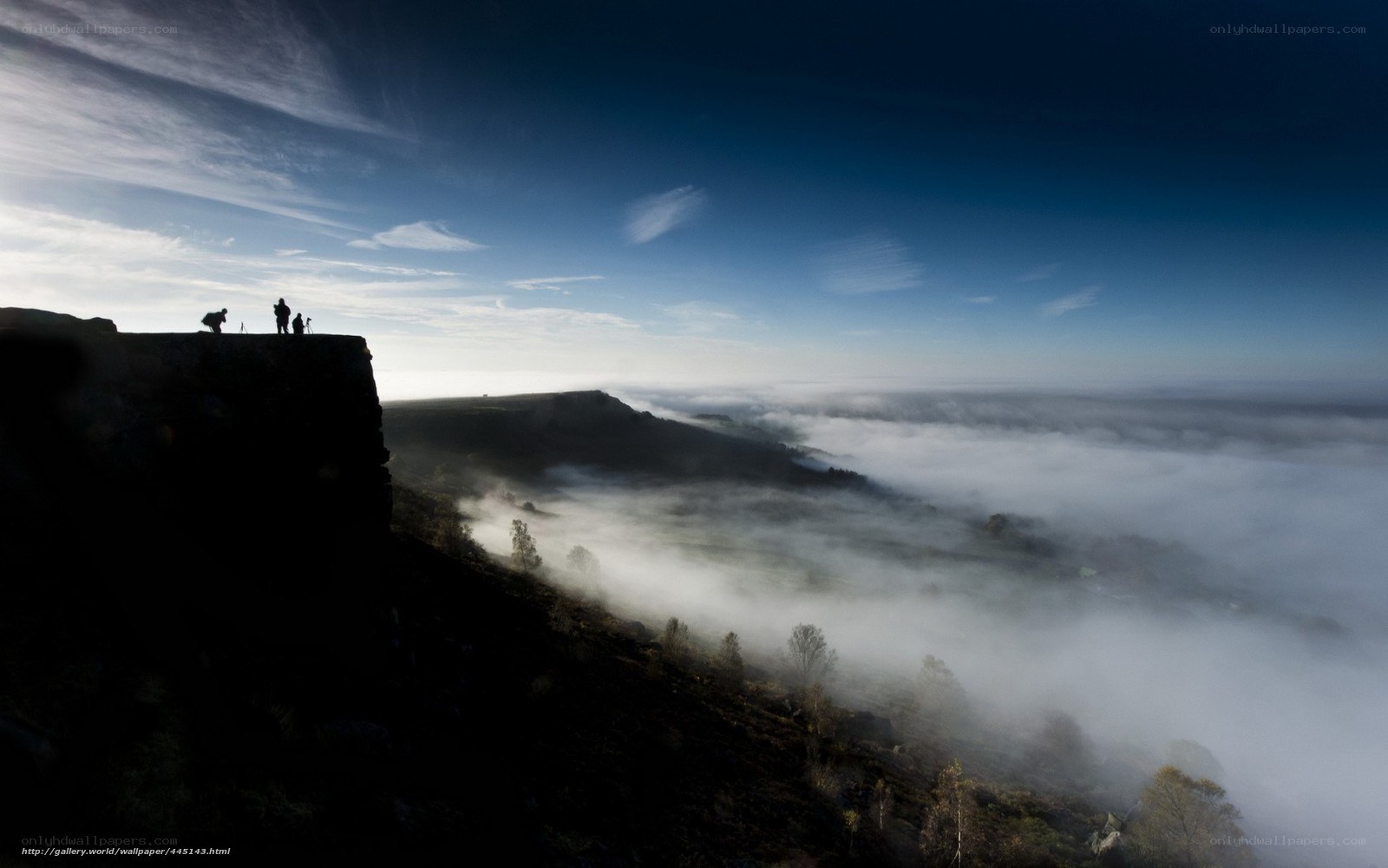 Foggy valley from cliff edge