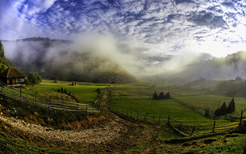 Foggy Valley with Haystacks