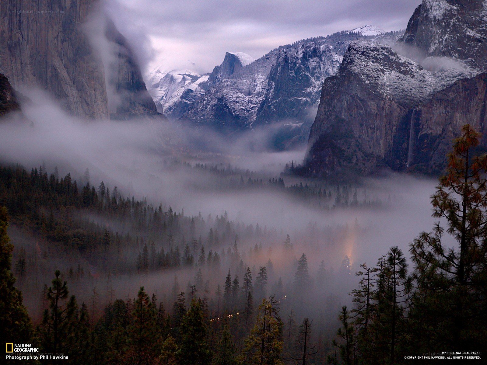 Foggy valley with snow-capped mountains